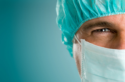 Mature male surgeon gazing and looking at camera at hospital, close up shot